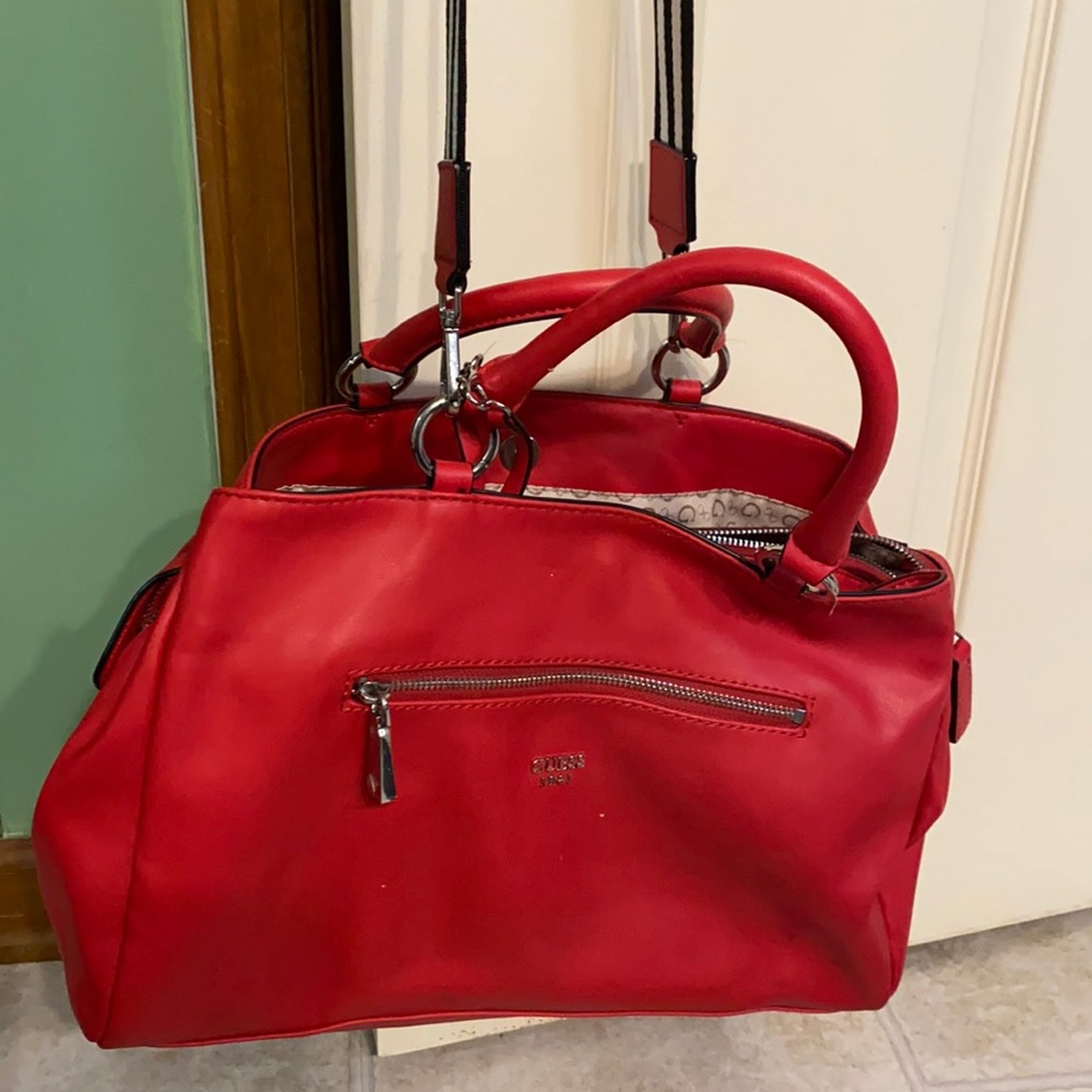 Used Guess satchel with guitar string shoulder handle in red